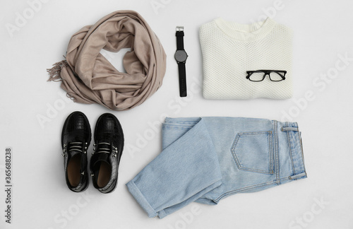 Set with ankle boots, stylish clothes and accessories on white background, top view
