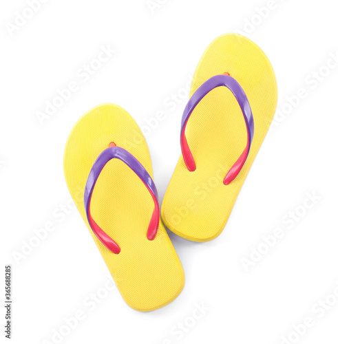 Pair of stylish yellow flip flops isolated on white, top view. Beach object