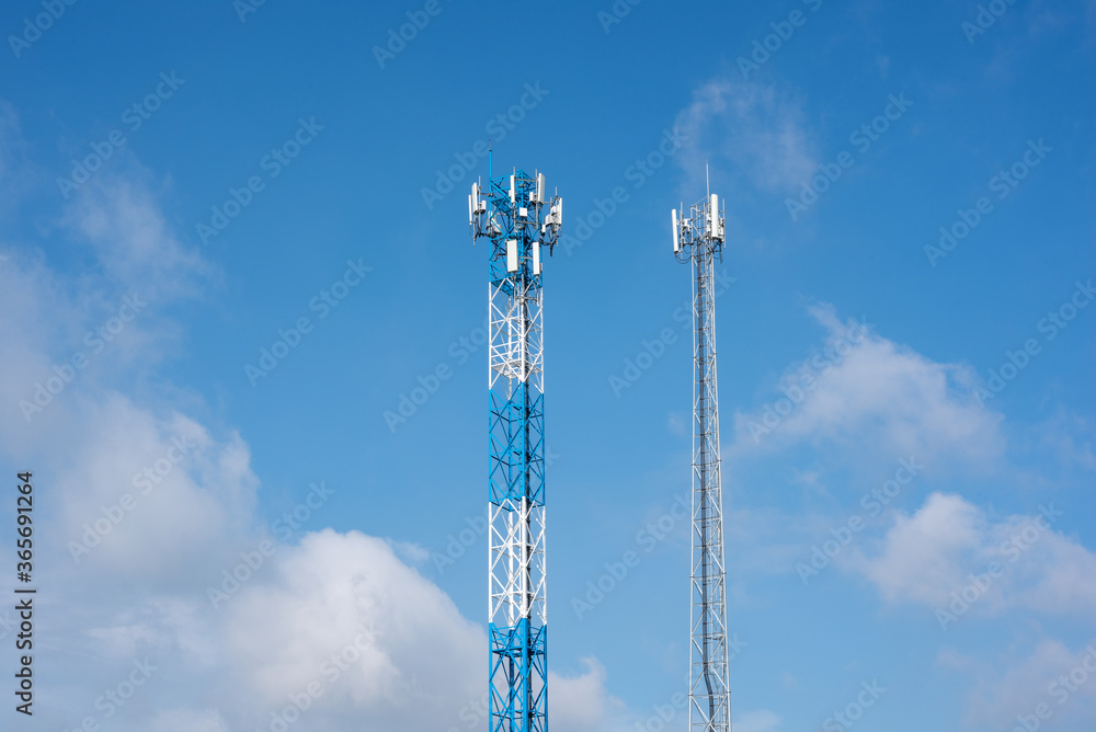 Wireless communication antenna transmitter. Telecommunication towers with blue sky.