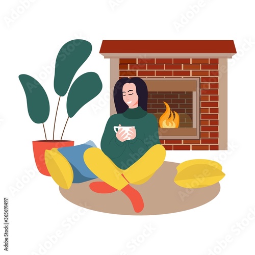 Girl sitting in cozy room with cup of tea or coffee