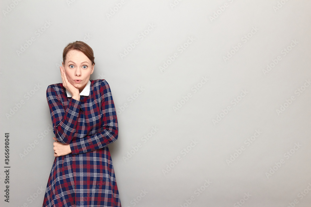 Portrait of shocked worried girl touching one cheek with hand Portrait of shocked worried girl touching one cheek with hand