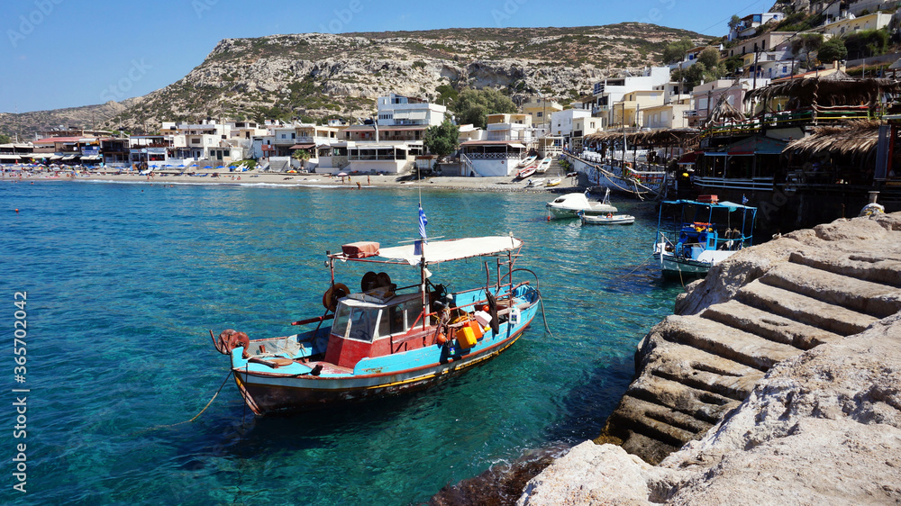 Matala village with fishing boat in Crete. Greece