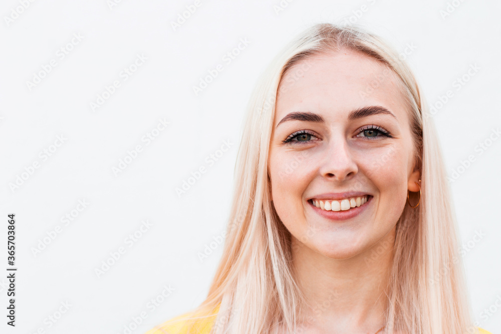 Pretty smiling joyfully female with fair hair, dressed casually, looking with satisfaction at camera, being happy. Studio shot of good-looking beautiful woman Pretty smiling joyfully female with fair hair, dressed casually, looking with satisfaction at camera, being happy. Studio shot of good-looking beautiful woman