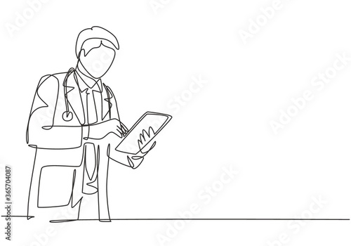 One single line drawing of young male doctor pose standing to read a journal health and medical record on tablet. Medical health care research concept continuous line draw design vector illustration