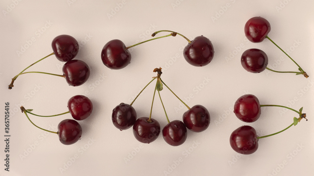 Many ripe cherries are on the table. Cherries with green tails. Vanilla toning Many ripe cherries are on the table. Cherries with green tails. Vanilla toning