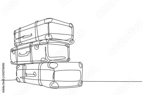 One continuous line drawing of old retro vintage leather suitcases stack. Classic travelling item concept single line draw graphic design vector illustration