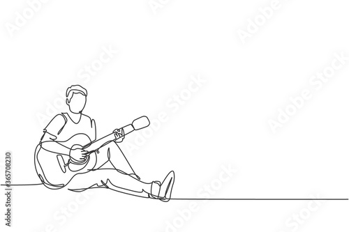 One continuous line drawing of young happy male guitarist sitting relax on the floor while playing acoustic guitar. Musician artist performance concept single line draw design vector illustration