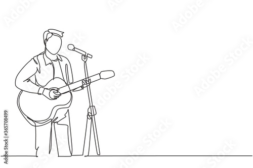 One continuous line drawing of young happy male guitarist playing acoustic guitar and singing on music festival stage. Musician artist performance concept single line draw design vector illustration