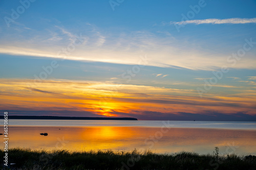 Long grass with vibrant ocean sunset background