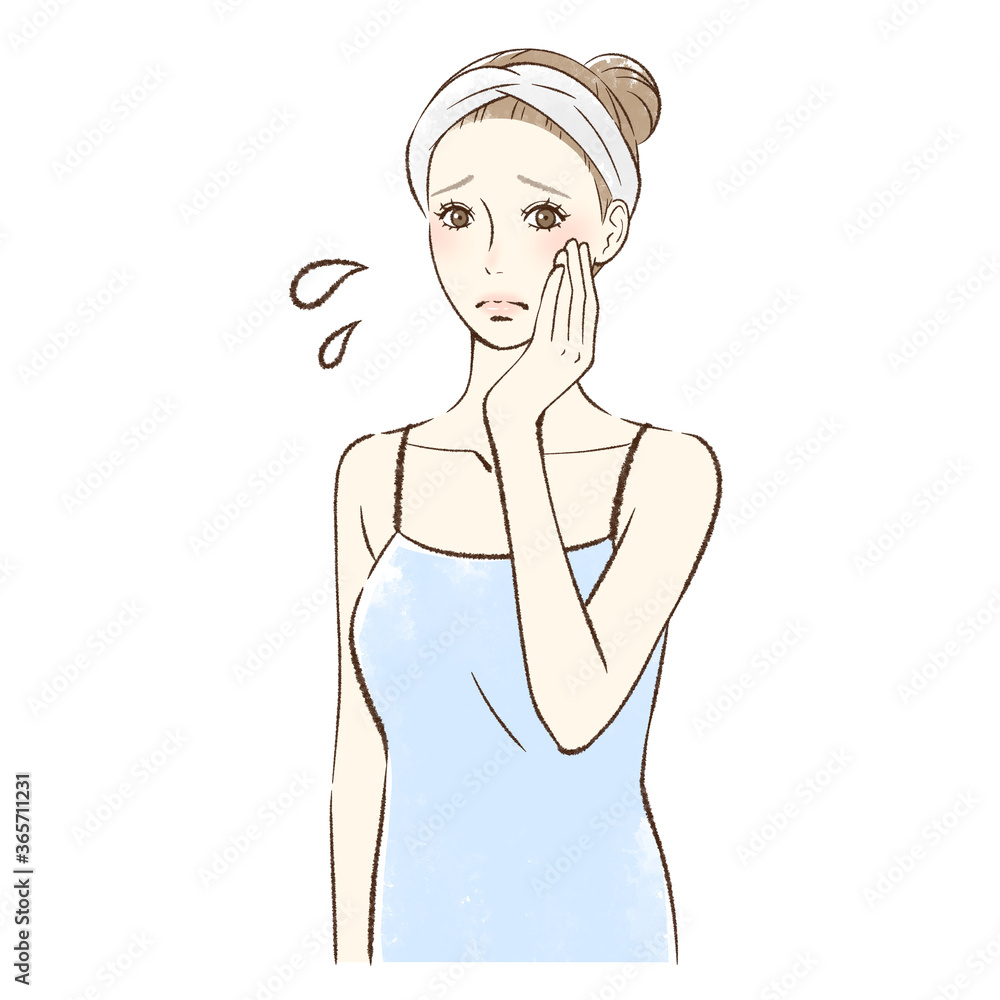 手のひらで頬をなでる不安そうな女性 手のひらで頬をなでる不安そうな女性