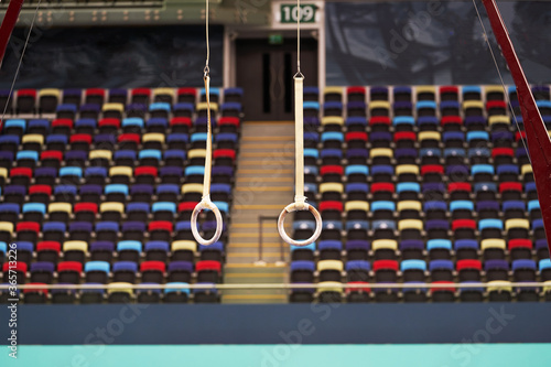 Gymnastic rings on gymnastic competition hall. Empty gymnastic rings © Gecko Studio
