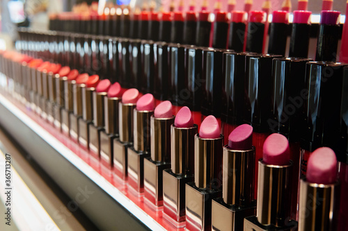 Multicolor lipstick makeup pallette on shelf in the shop. Beauty, Cosmetic, Make up, Fashion Concept. Selective Focus.
