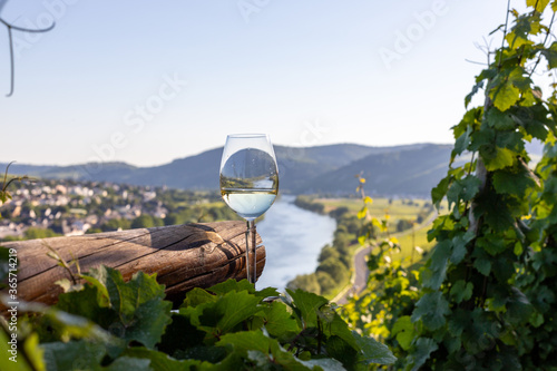 Filled wine glass next to wooden beam