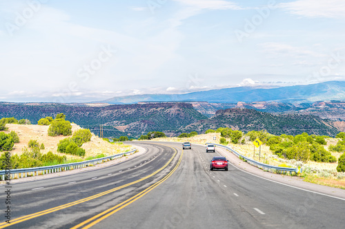 Santa Fe county, New Mexico desert with cars on road highway to Los Alamos driving on street 502 west photo