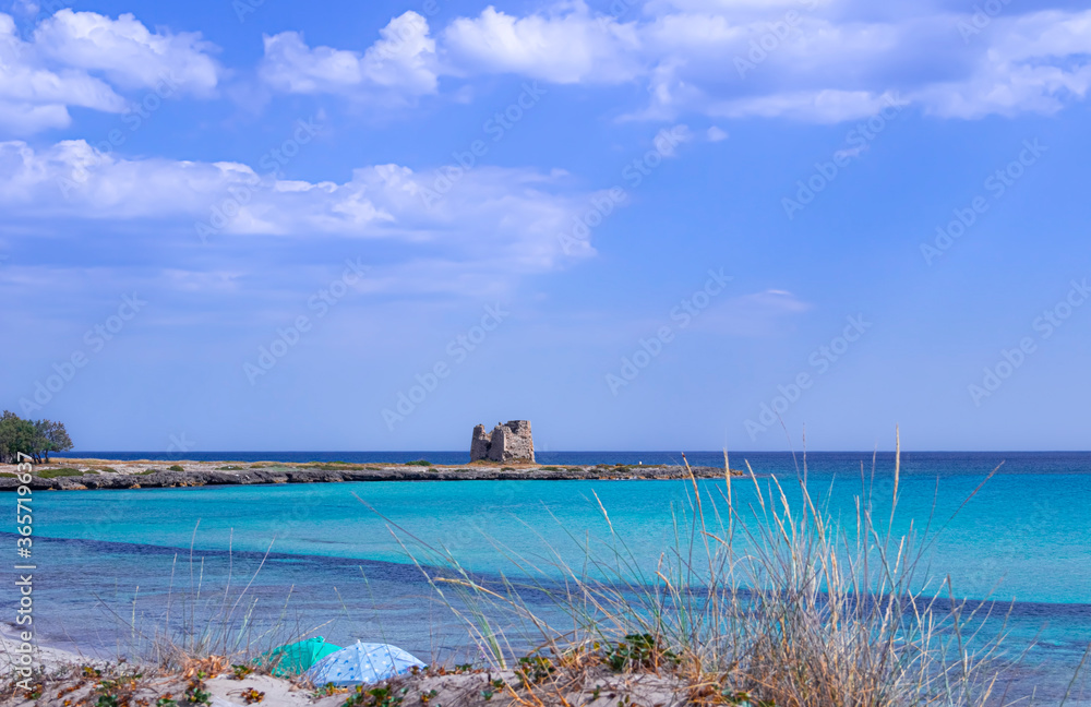 Marina di Lizzano: Torretta Beach, Apulia (Italy).On background Zozzoli Watchtower. The coastline is characterized by a alternation of sandy coves and jagged cliffs overlooking a crystalline sea.