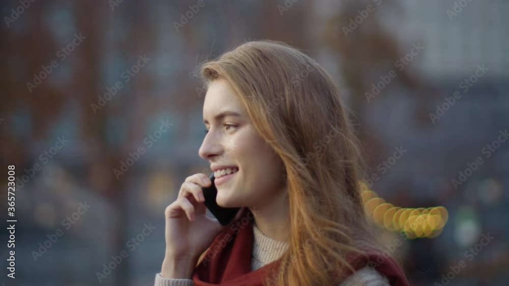 Joyful girl speaking phone on street. Hipster woman walking with phone outdoors. Joyful girl speaking phone on street. Hipster woman walking with phone outdoors.