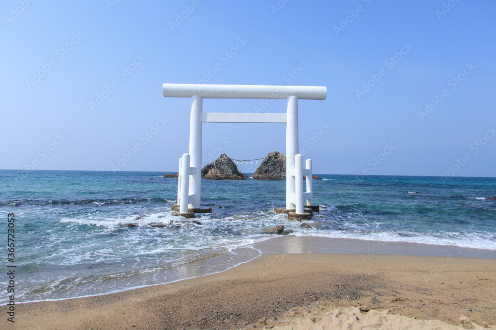 Meotoiwa and White Torii gate near the sea at Sakurai Futamigaura Itoshima, Fukuoka Prefecture, Japan Meotoiwa and White Torii gate near the sea at Sakurai Futamigaura Itoshima, Fukuoka Prefecture, Japan
