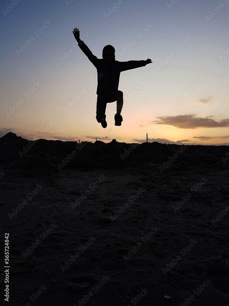 man jumping on the beach