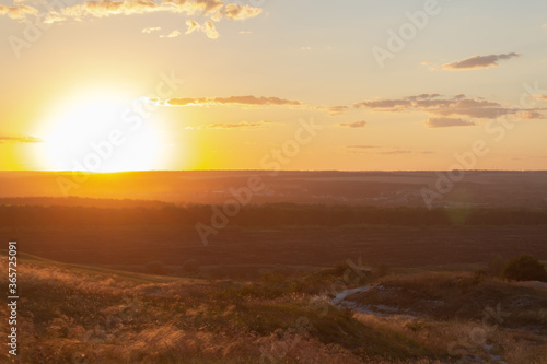 sunset over the fields, view from the mountain, path down