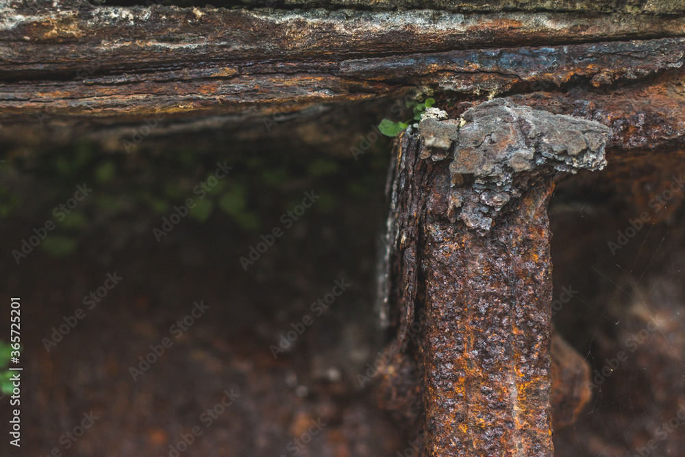 Fototapeta premium Closeup of a rough and rusty construction. Old and with moss growing