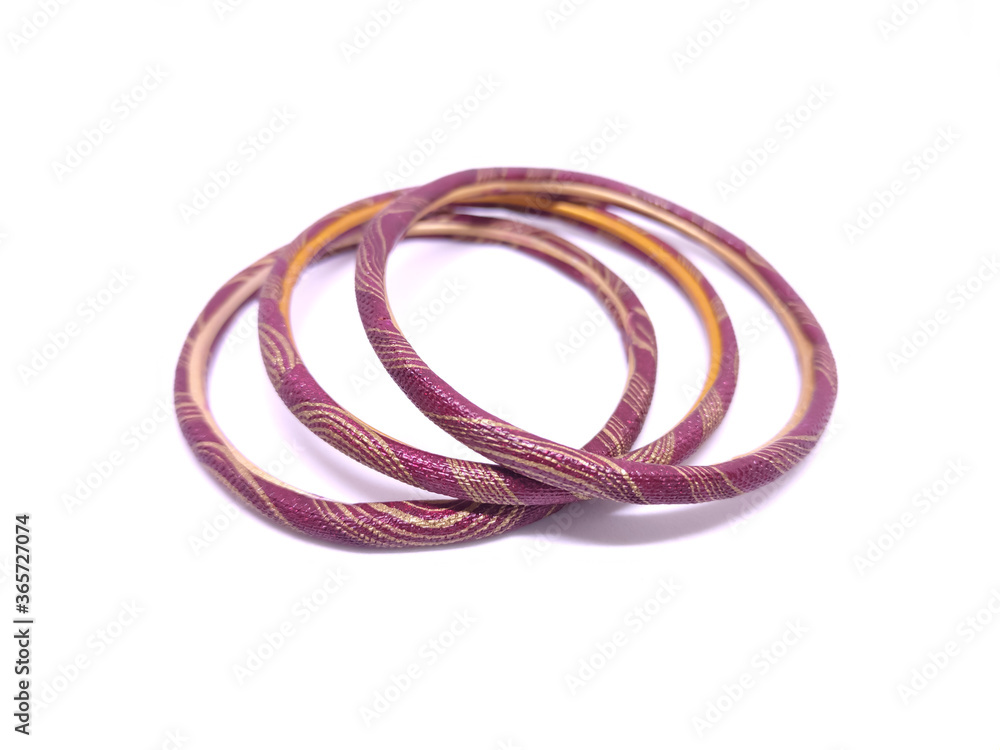 Three multicolored Bangles isolated on white background. Bangles are traditionally rigid bracelets, originating from the Indian subcontinent, which are usually made of metal, wood, glass or plastic. Three multicolored Bangles isolated on white background. Bangles are traditionally rigid bracelets, originating from the Indian subcontinent, which are usually made of metal, wood, glass or plastic.