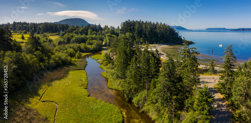Aerial View of a Watershed on Lummi Island, Washington. Drone shot of a slough that lies adjacent to Legoe Bay on an island in the northwest corner of Washington state. 