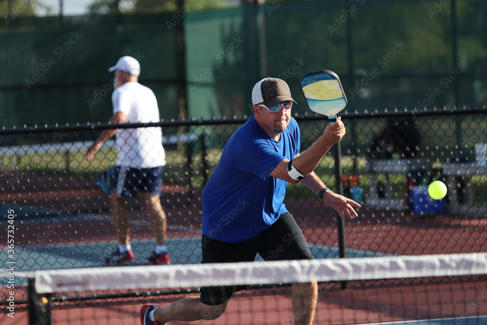 A volley is hit during a pickleball match