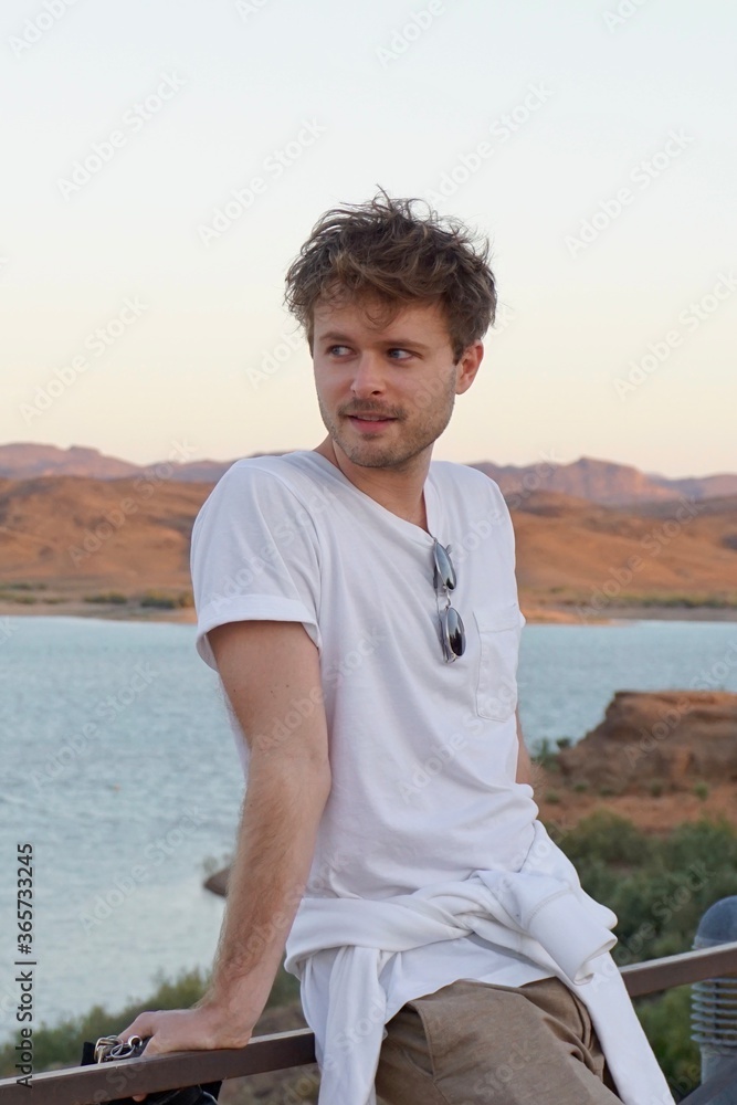 Casual young man on fence