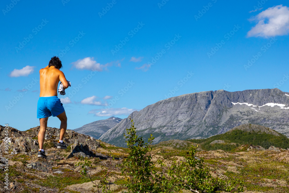 Young man on a summer trip in the mountains at Gaasheia, Nordland county