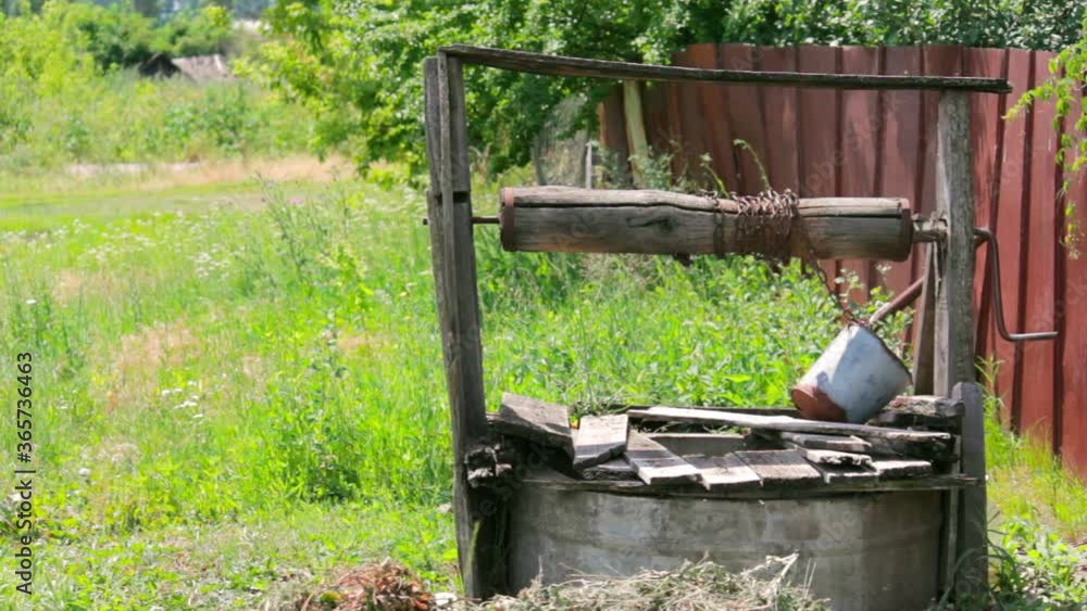 A manual well in front of a rural house providing groundwater as a source of drinking water for the villagers. A manual well in front of a rural house providing groundwater as a source of drinking water for the villagers.