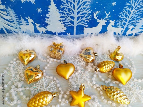 Gold chrisymas toys on the blue white background photo