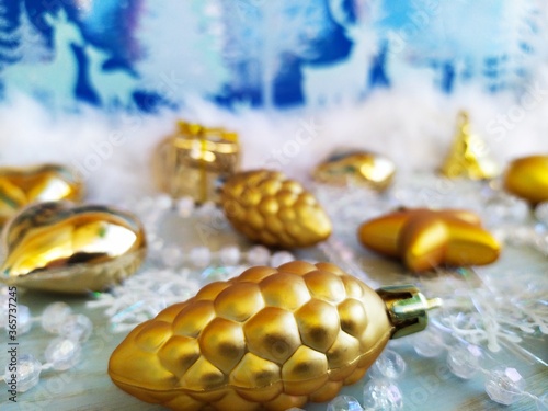 Gold chrisymas toys on the blue white background photo