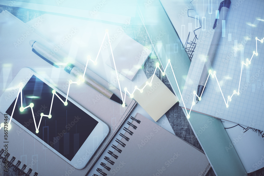 Fototapeta premium Multi exposure of forex graph hologram over desktop with phone. Top view. Mobile trade platform concept.