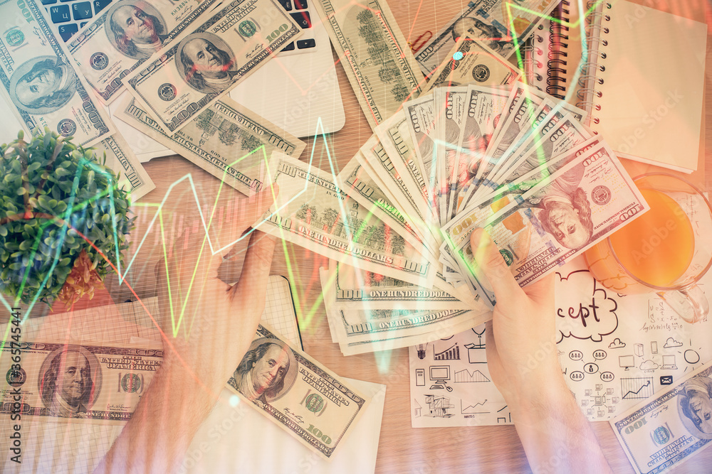 Multi exposure of financial graph drawing hologram and USA dollars bills and man hands. Analysis concept. Multi exposure of financial graph drawing hologram and USA dollars bills and man hands. Analysis concept.
