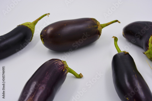 Fresh blue, purple eggplants recently picked and arranged on a matte white background. Delicious vegetables that grow in Ukraine, healthy and wholesome food for every day.
