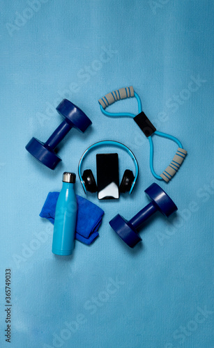 blue exercise equipment for sports activities on ground with blue background
