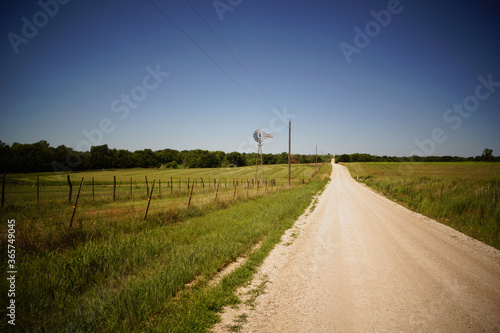 Road in the countryside with a farm windmill. photo