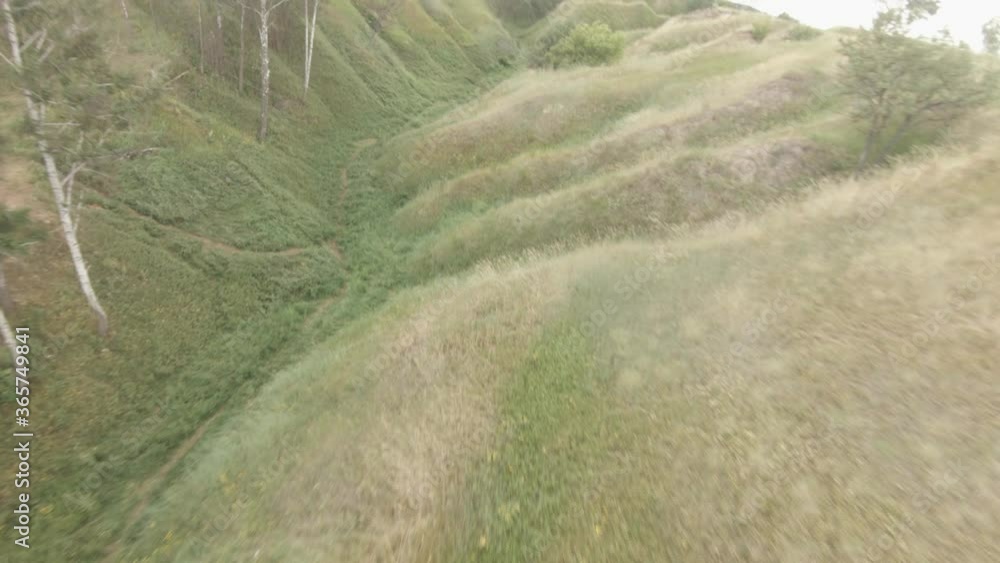 Cinematic Drone flying over the grass canyon in nature. Creative authentic aerial shot of summer countryside landscape. Cinematic Drone flying over the grass canyon in nature. Creative authentic aerial shot of summer countryside landscape.