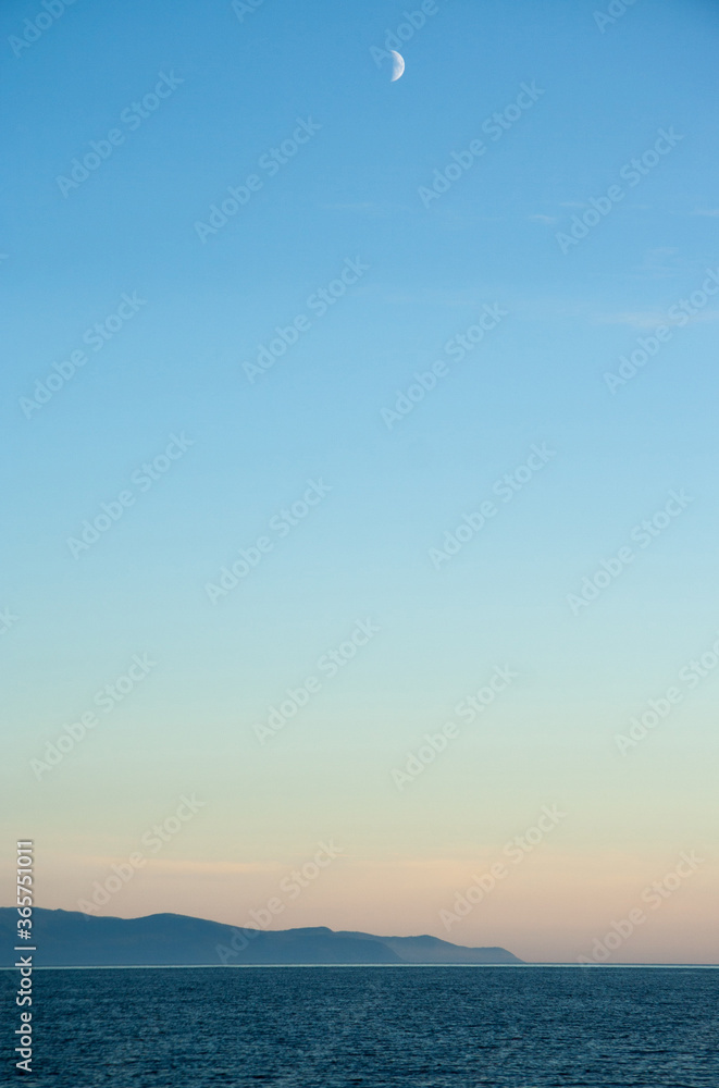 Minimal photo of the moon during sunset with copy space