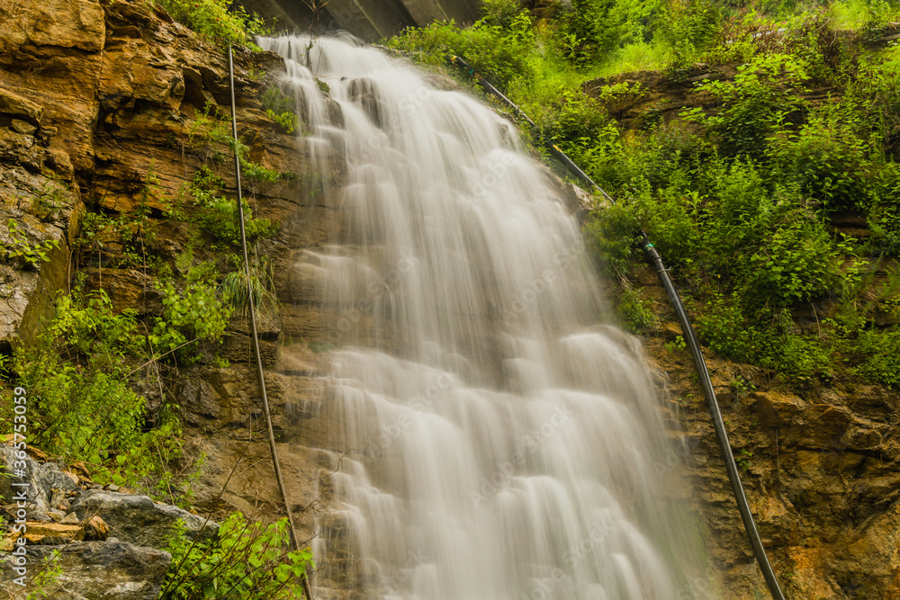Beautiful natural waterfall cascading down a hill.