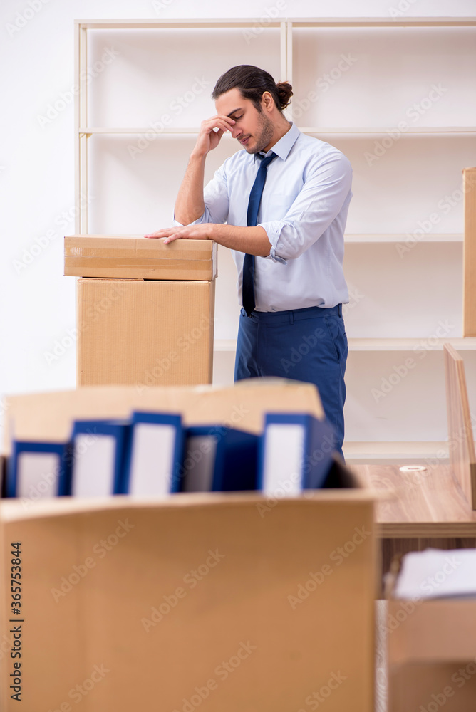Young male employee in relocation concept