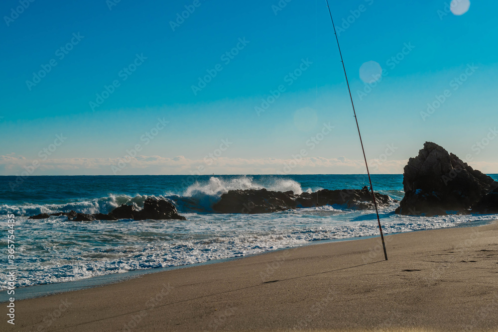 Fishing pole stuck in sand