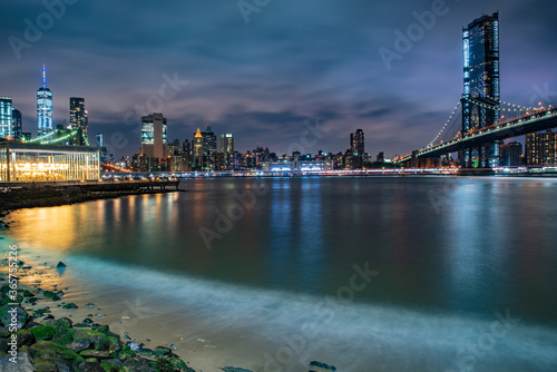 View of Brooklyn and Manhattan at night. Brooklyn Bridge, Manhattan Bridge and One World Trade Center from Empire-Fulton Ferry State Park, NY