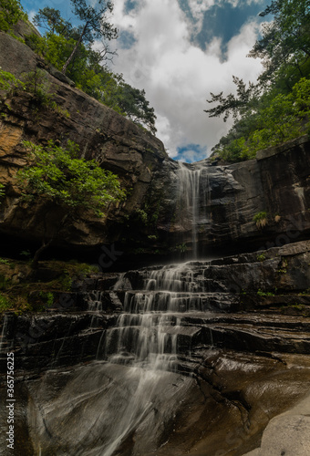 Waterfall cascading down mountainside.