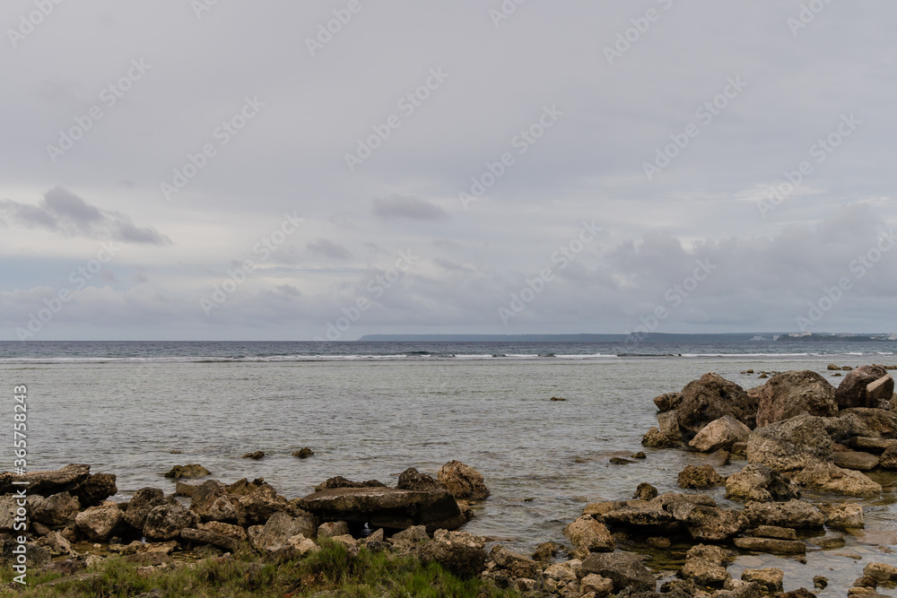 Seascape of rocky shoreline on a cloudy day