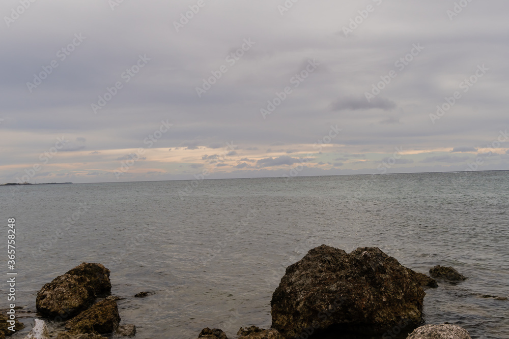 Seascape of rocky shoreline on a cloudy day