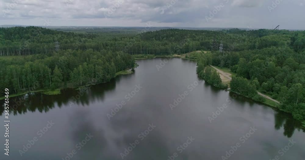 Flying over a beautiful forest lake on a summer day.
Flying over a beautiful forest lake on a summer day.