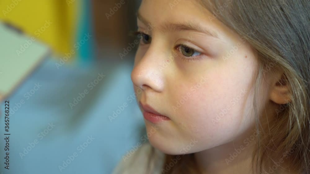 close-up. little girl doing makeup, apply powder on face. close-up. little girl doing makeup, apply powder on face.
