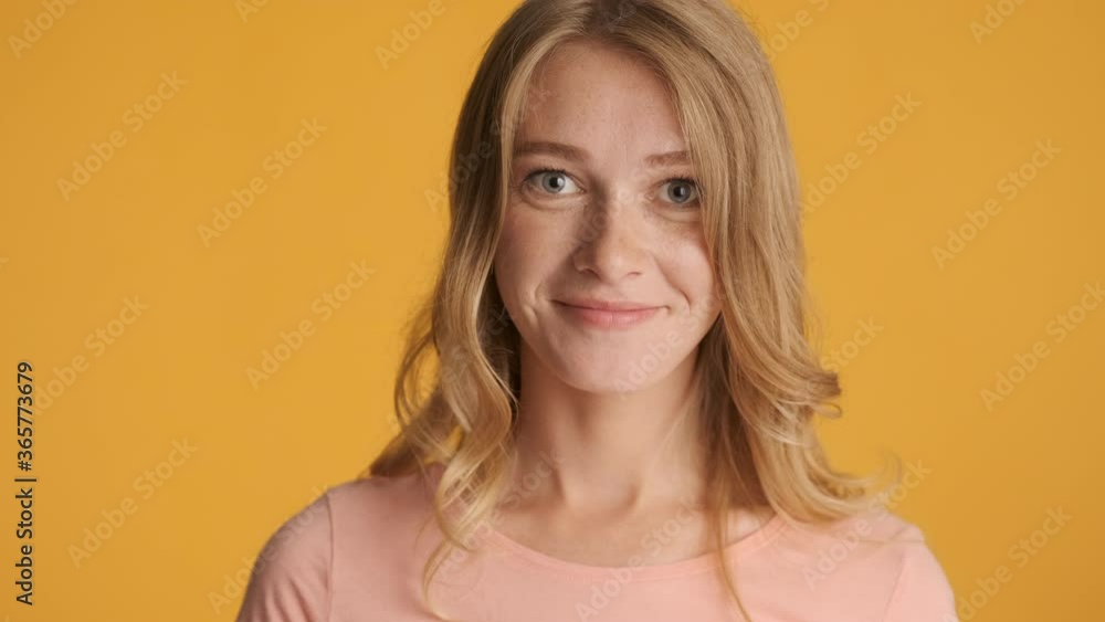 Beautiful blond girl surprisingly looking in camera over colorful background. Wow expression Beautiful blond girl surprisingly looking in camera over colorful background. Wow expression