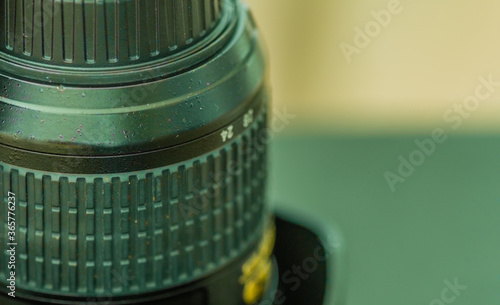 Macro of 24 to 70 camera lens and lens cap with soft blurred background. photo